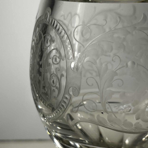 Pair of stemmed glasses in thick cut crystal with scrollwork and monogram decoration, Bohemia ca 1900