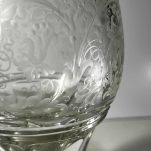 Pair of stemmed glasses in thick cut crystal with scrollwork and monogram decoration, Bohemia ca 1900