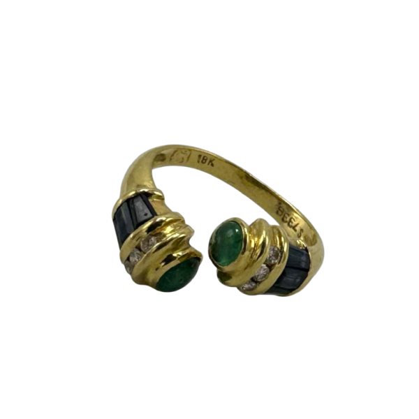 toi et moi' ring in 18 K yellow gold set with sapphires and emerald cabochon