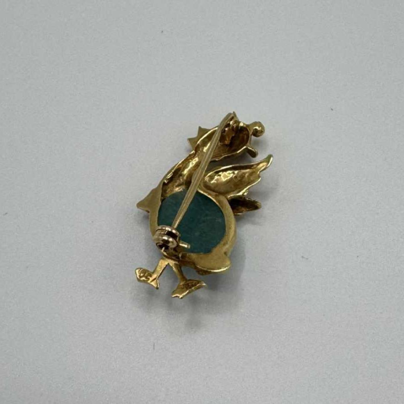 Small brooch in 18k yellow gold set with a turquoise stone. Circa 1970