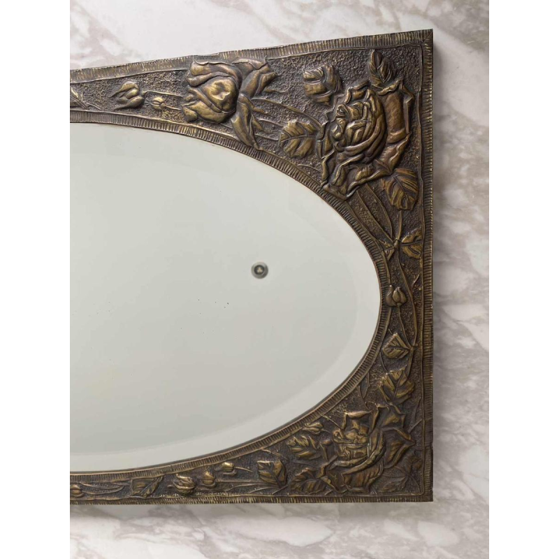 Oval Art Nouveau mirror in repoussé brass with floral decoration, early 20th c