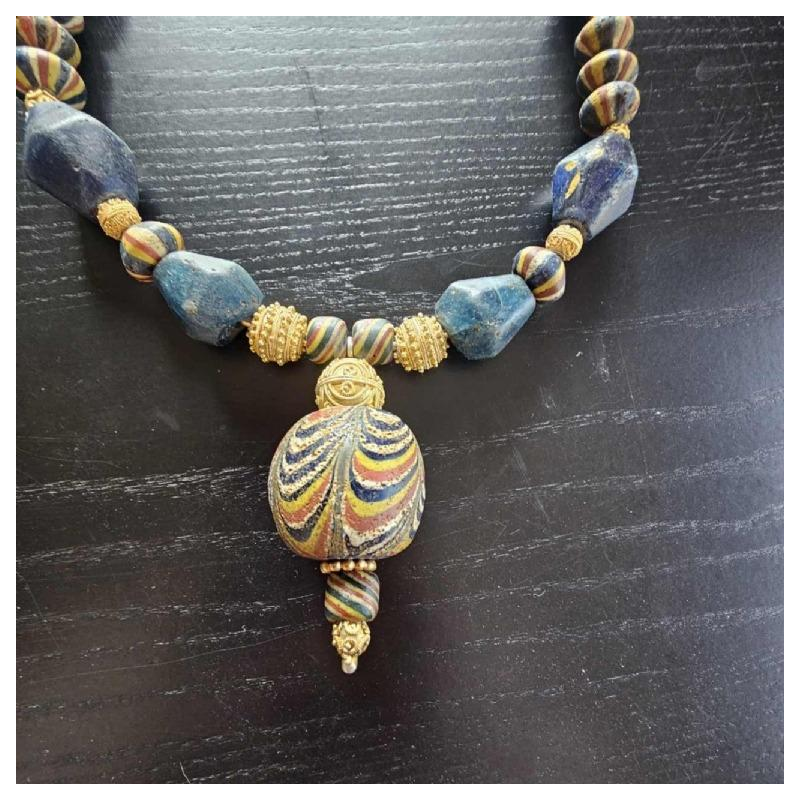 Ketting van zeer oude glazen kralen, waaronder een centrale JATIM of PELANGI kraal in 4 kleuren