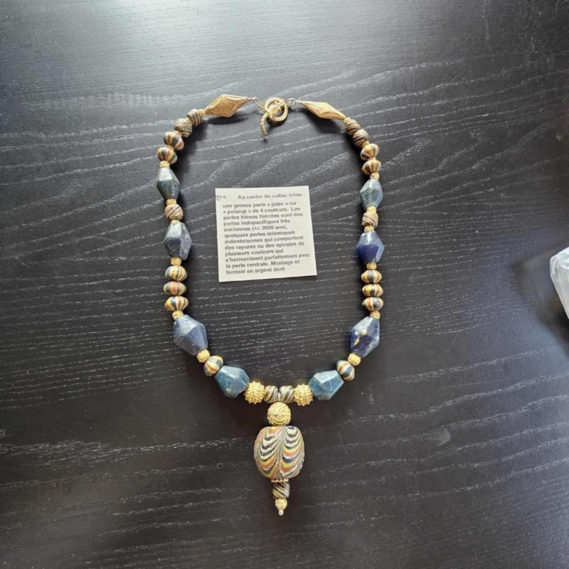Necklace of very old glass beads, including a central JATIM or PELANGI bead in 4 colours