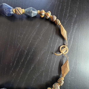 Necklace of very old glass beads, including a central JATIM or PELANGI bead in 4 colours