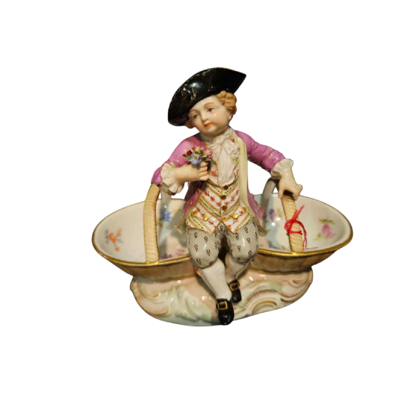 Meissen porcelain 'Child with baskets' polychrome salt shaker statuette, 19th century