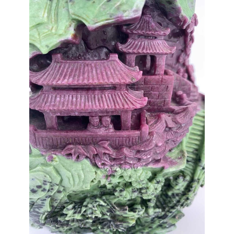 Rock carved from zoisite ruby depicting a lively Asian landscape