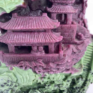 Rock carved from zoisite ruby depicting a lively Asian landscape
