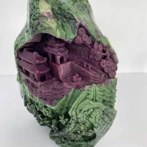 Rock carved from zoisite ruby depicting a lively Asian landscape