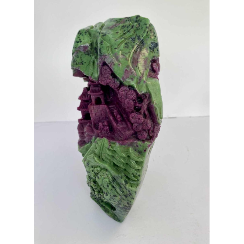 Rock carved from zoisite ruby depicting a lively Asian landscape