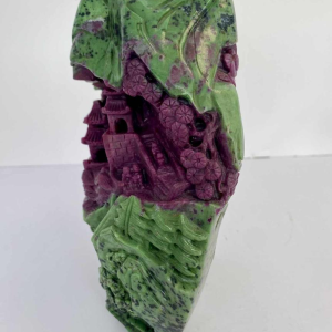 Rock carved from zoisite ruby depicting a lively Asian landscape