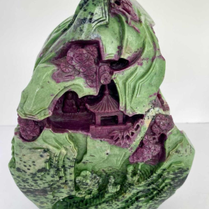Rock carved from zoisite ruby depicting a lively Asian landscape