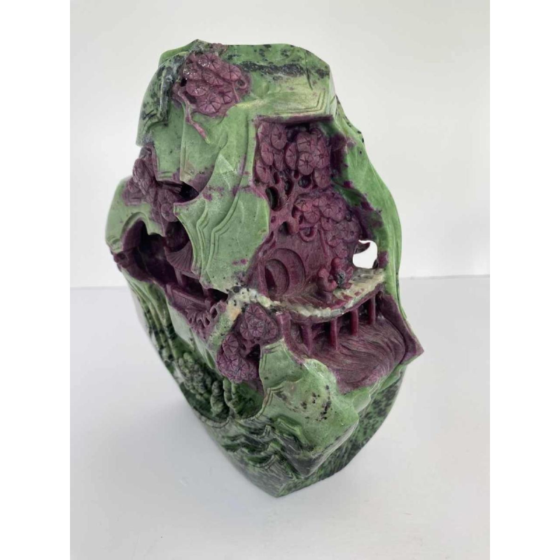 Rock carved from zoisite ruby depicting a lively Asian landscape