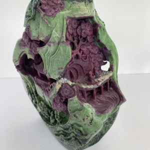 Rock carved from zoisite ruby depicting a lively Asian landscape