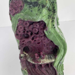 Rock carved from zoisite ruby depicting a lively Asian landscape