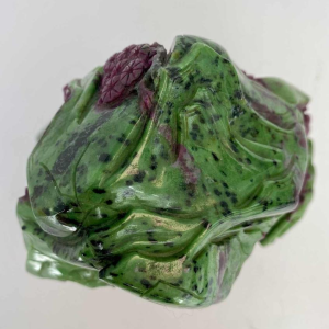 Rock carved from zoisite ruby depicting a lively Asian landscape