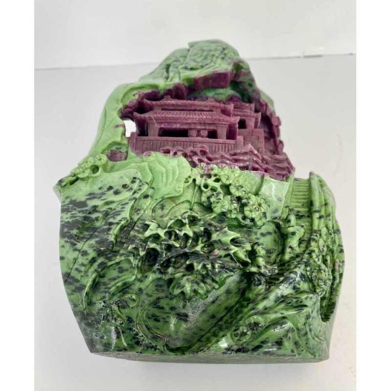Rock carved from zoisite ruby depicting a lively Asian landscape