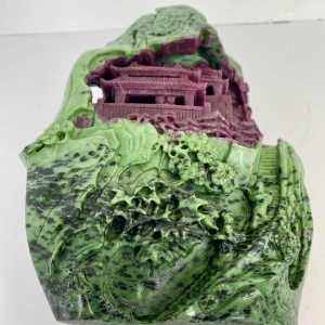 Rock carved from zoisite ruby depicting a lively Asian landscape