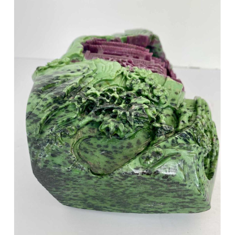 Rock carved from zoisite ruby depicting a lively Asian landscape