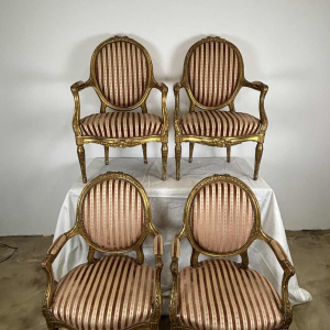 Suite of four medallion-back armchairs, carved gilt wood, 19th c