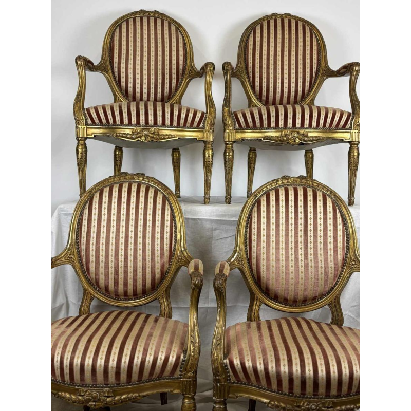 Suite of four medallion-back armchairs, carved gilt wood, 19th c