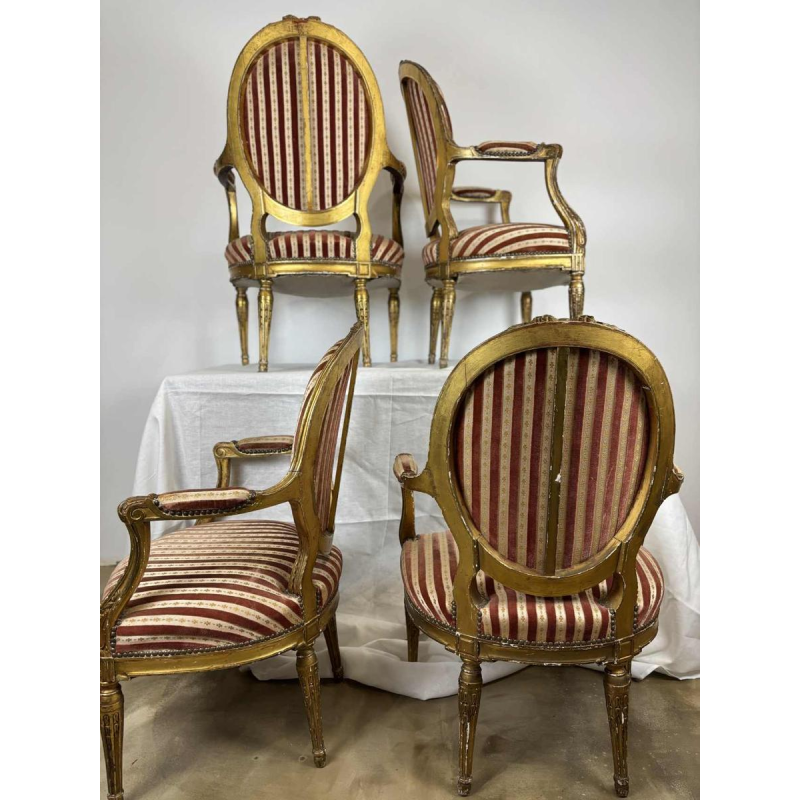Suite of four medallion-back armchairs, carved gilt wood, 19th c