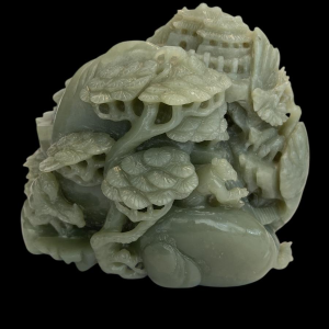 Celadon jade carved block, with trees, figures and rocks, 20th century