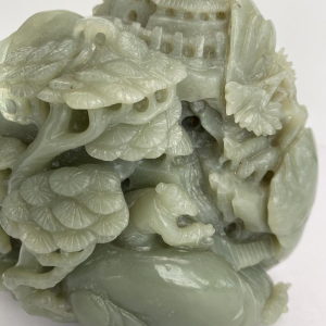 Celadon jade carved block, with trees, figures and rocks, 20th century
