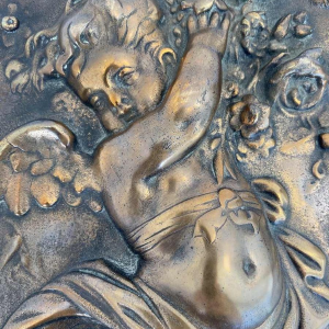 Bas-relief “Putto Carrying Flowers” romantic bronze sculpture, late 19th c