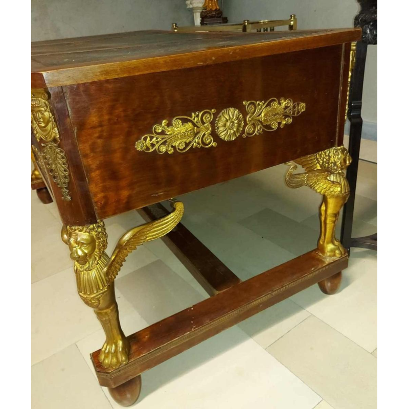 Mahogany desk supported by four winged bronze sphinxes + armchair, Empire style, 19th century