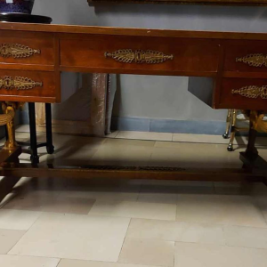 Mahogany desk supported by four winged bronze sphinxes + armchair, Empire style, 19th century