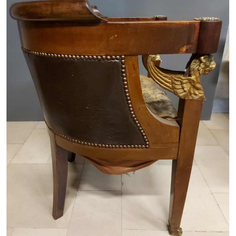 Mahogany desk supported by four winged bronze sphinxes + armchair, Empire style, 19th century