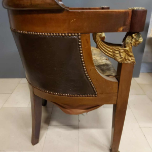 Mahogany desk supported by four winged bronze sphinxes + armchair, Empire style, 19th century