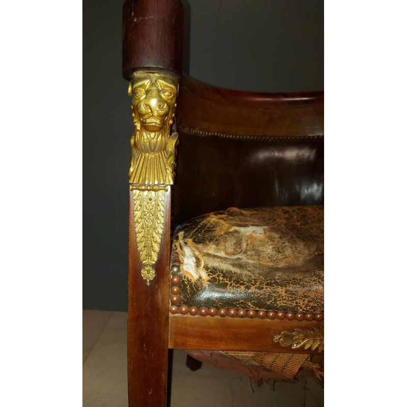 Mahogany desk supported by four winged bronze sphinxes + armchair, Empire style, 19th century