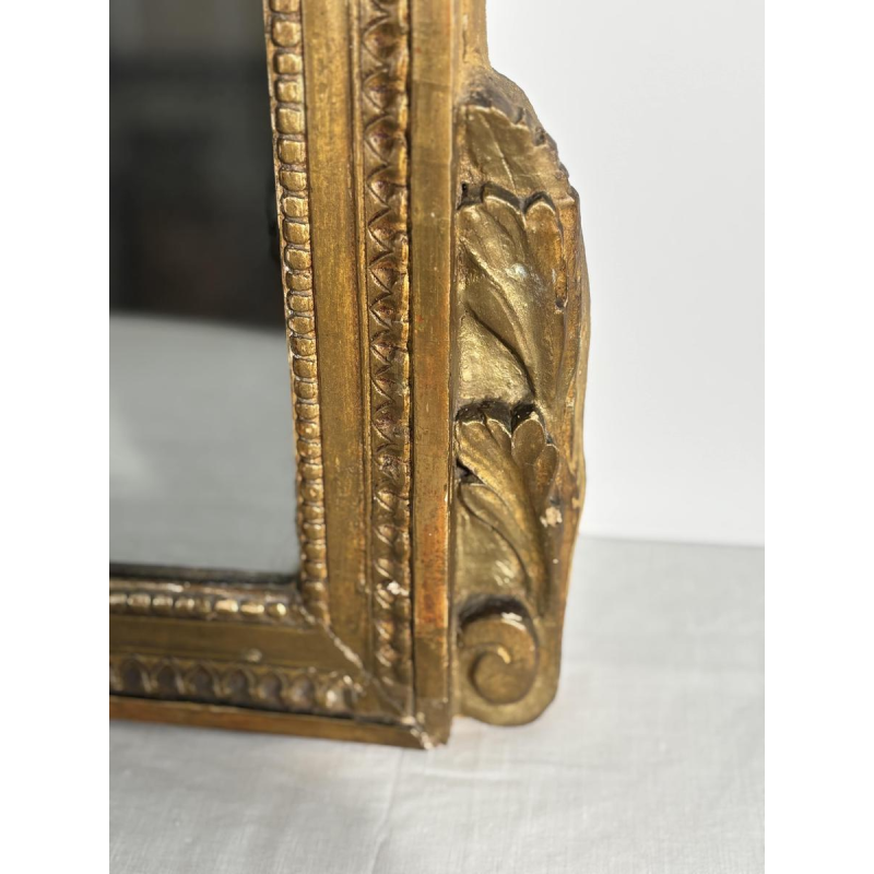 Mirror with a carved giltwood pediment, France, early 19th century