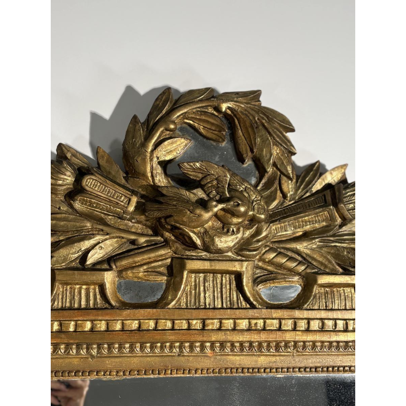 Mirror with a carved giltwood pediment, France, early 19th century