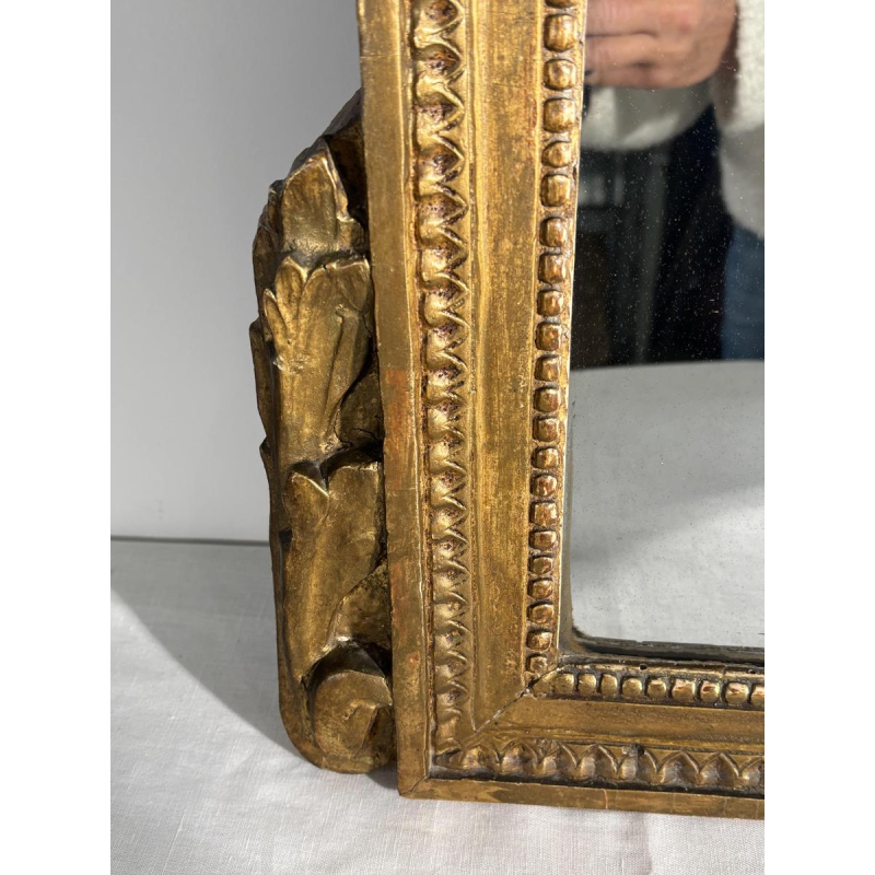 Mirror with a carved giltwood pediment, France, early 19th century