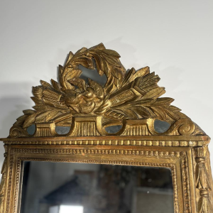 Mirror with a carved giltwood pediment, France, early 19th century
