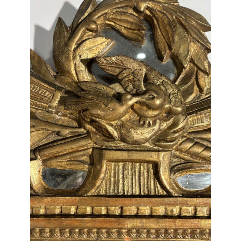 Mirror with a carved giltwood pediment, France, early 19th century