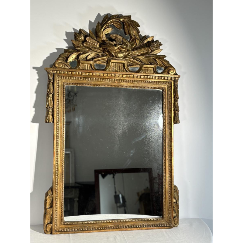 Mirror with a carved giltwood pediment, France, early 19th century
