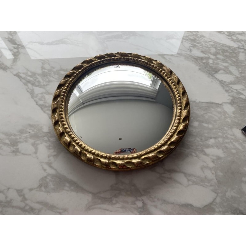 Circular "witch's eye" mirror in gilded carved wood