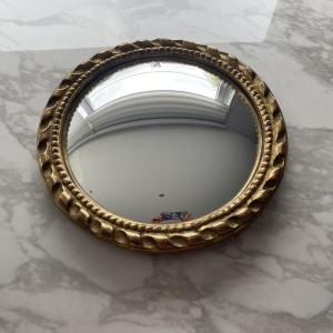 Circular "witch's eye" mirror in gilded carved wood