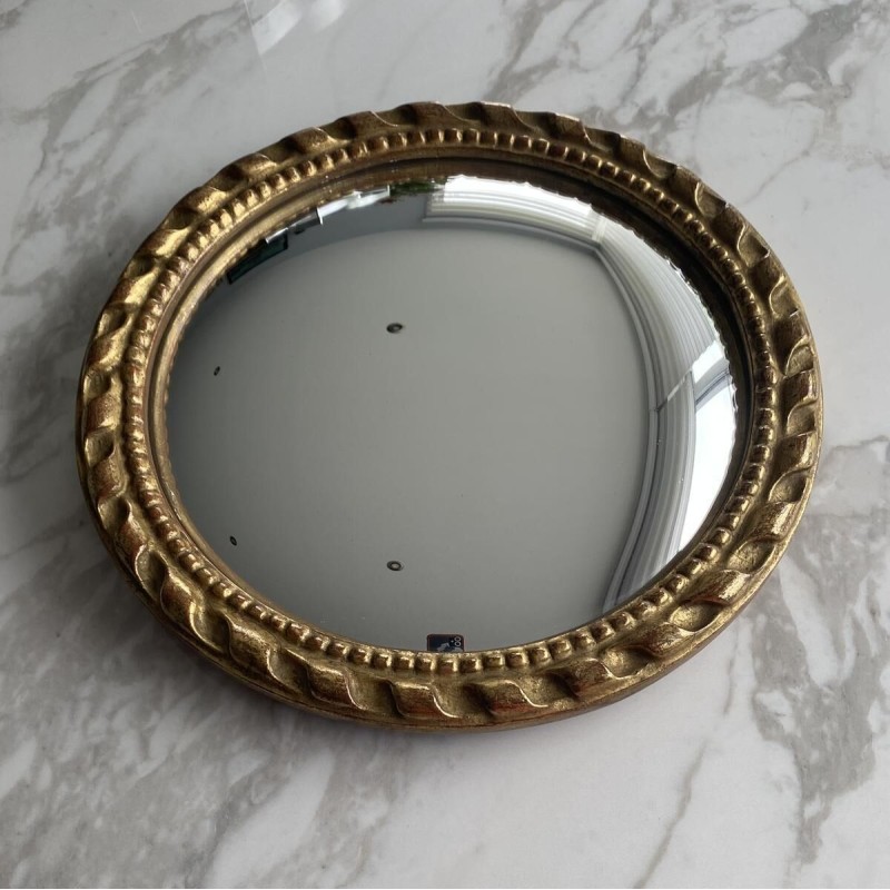 Circular "witch's eye" mirror in gilded carved wood