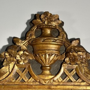 Mirror with a wooden and gilded stucco pediment - Louis XVI period - 18th century
