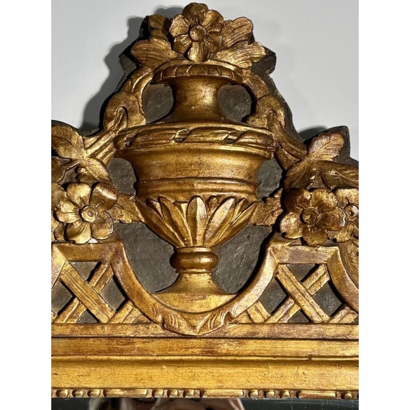 Mirror with a wooden and gilded stucco pediment - Louis XVI period - 18th century