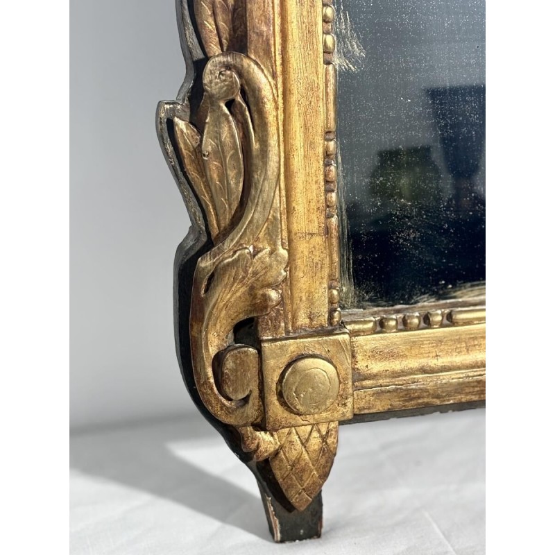 Mirror with a wooden and gilded stucco pediment - Louis XVI period - 18th century