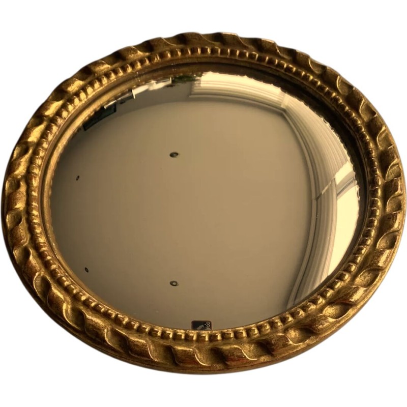 Circular "witch's eye" mirror in gilded carved wood