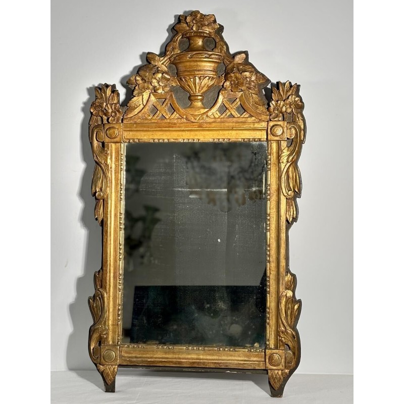 Mirror with a wooden and gilded stucco pediment - Louis XVI period - 18th century