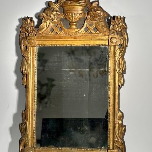 Mirror with a wooden and gilded stucco pediment - Louis XVI period - 18th century