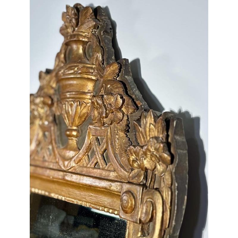 Mirror with a wooden and gilded stucco pediment - Louis XVI period - 18th century