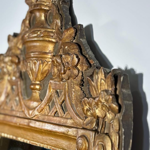 Mirror with a wooden and gilded stucco pediment - Louis XVI period - 18th century